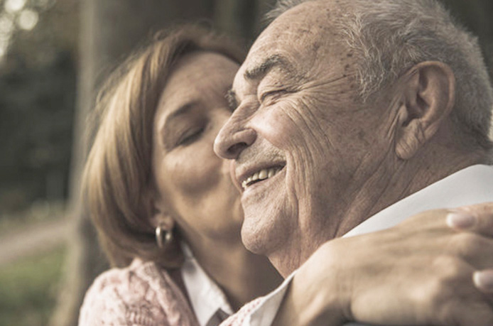 Elderly couple holding hands